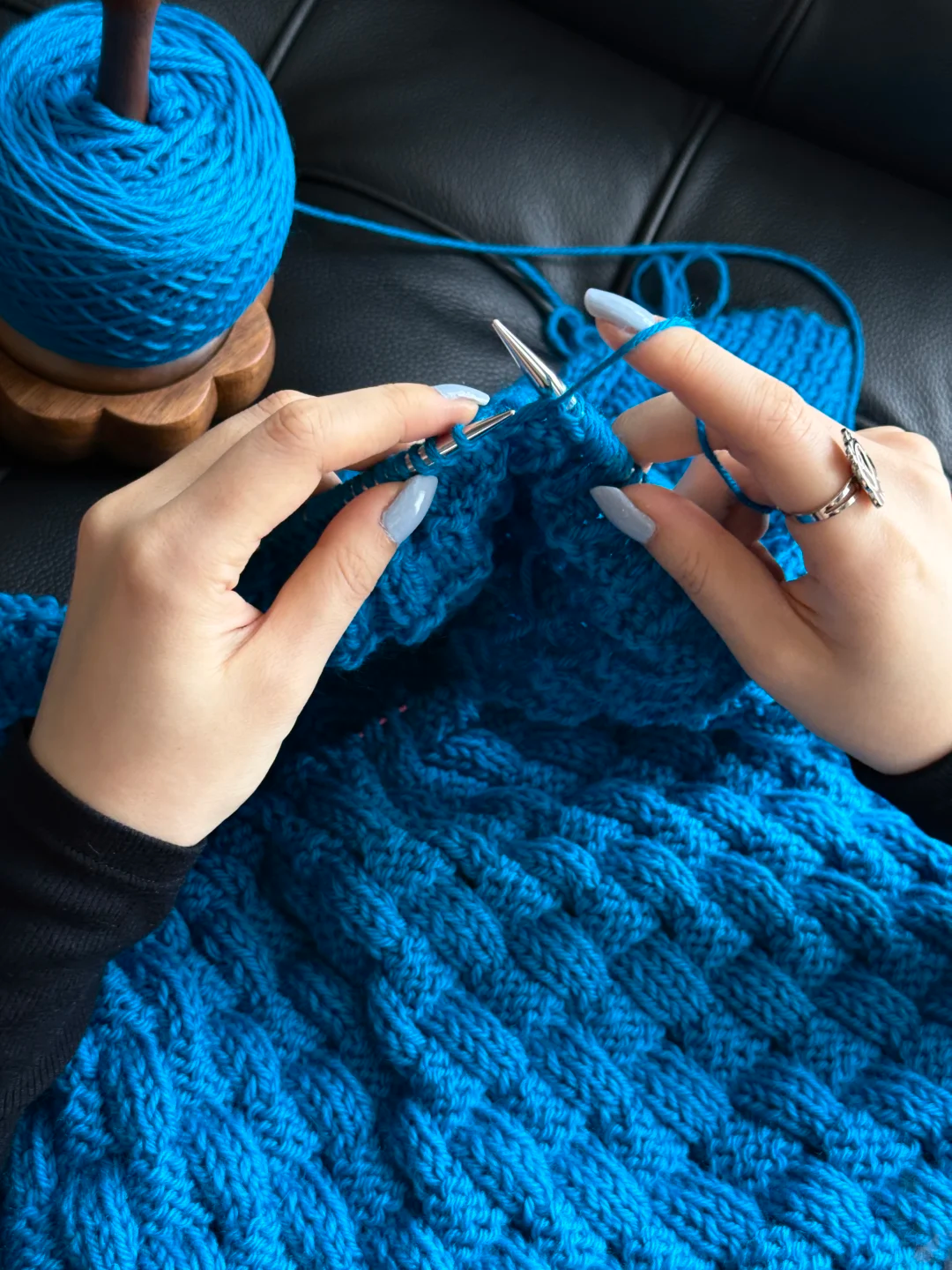 Blue hand-crocheted pet sweater in progress