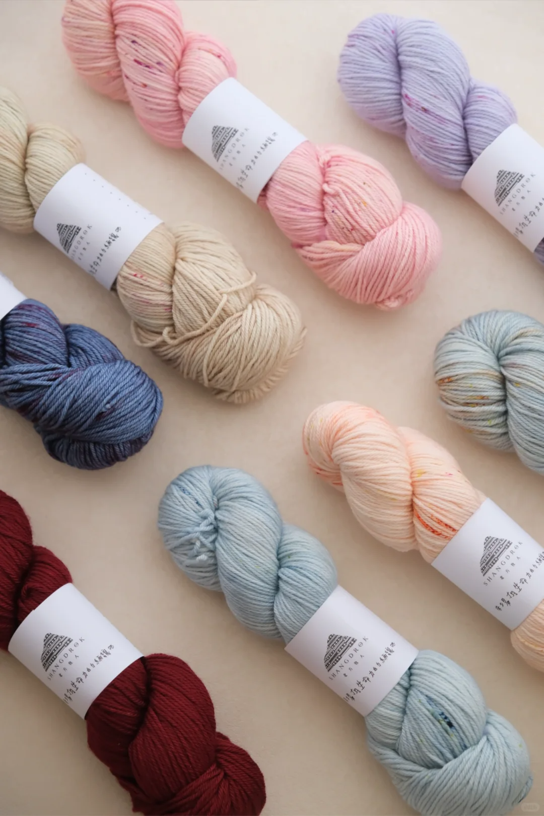 Pastel yarn skeins arranged on a table